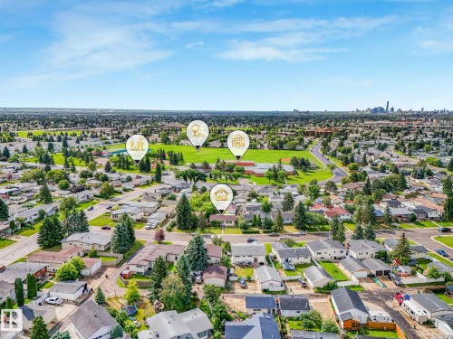 Expansive residential area featuring numerous single-story homes, mature trees, and paved streets - 9315 151 Avenue, Edmonton, AB 