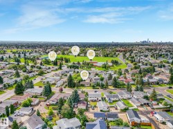 Expansive residential area featuring numerous single-story homes, mature trees, and paved streets - 