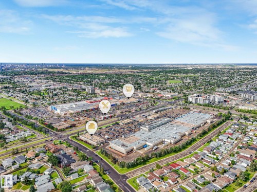 Aerial overview showcasing a prominent retail center surrounded by residential neighborhoods - 9315 151 Avenue, Edmonton, AB 