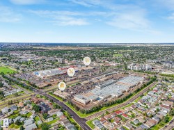 Aerial overview showcasing a prominent retail center surrounded by residential neighborhoods - 