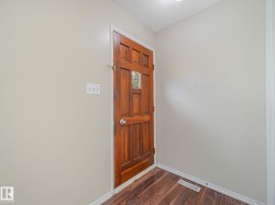 Rich wood-paneled door with an integrated window pane - 