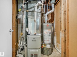 Utility space featuring a Concord furnace and a Rheem water heater - 
