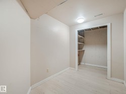 Room featuring light-toned walls, wood-finish flooring, and a flush-mount ceiling light - 