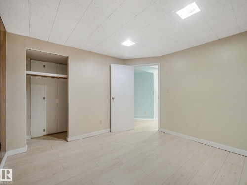 Light-toned wood-finish flooring extending throughout the space - 9315 151 Avenue, Edmonton, AB 