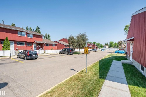 Attached residential structures featuring red siding and white trim - 10678 Beaumaris Road Nw, Edmonton, AB 
