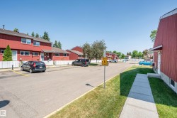 Attached residential structures featuring red siding and white trim - 