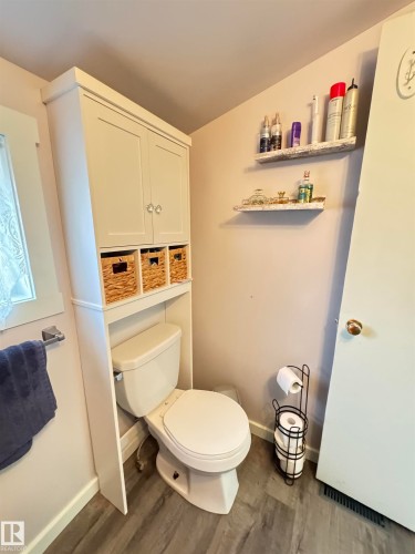 White over-the-toilet cabinetry with upper storage and open cubbies - 4912 49 Avenue, Onoway, AB 