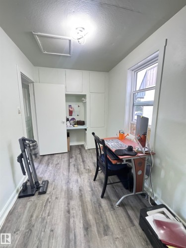 Room featuring wood-finish flooring, white walls, and a window for natural light - 4912 49 Avenue, Onoway, AB 