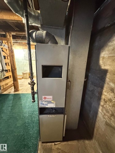Forced air furnace unit with exposed ductwork and utility piping - 4912 49 Avenue, Onoway, AB 