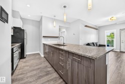 Modern kitchen island with granite countertop and undermount sink - 