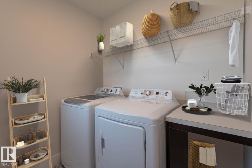 Dedicated laundry area featuring a full-size washer and dryer - 2635 Donaghey Crescent, Edmonton, AB 