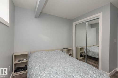 Room featuring wood-finish flooring, light grey painted walls, and white trim - 2635 Donaghey Crescent, Edmonton, AB 