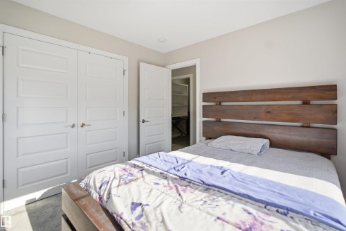 Bedroom featuring white paneled doors, light grey wall paint, recessed lighting, and a closet with built-in shelving - 1234 Daniels Crescent, Edmonton, AB - Indoor Photo Showing Bedroom