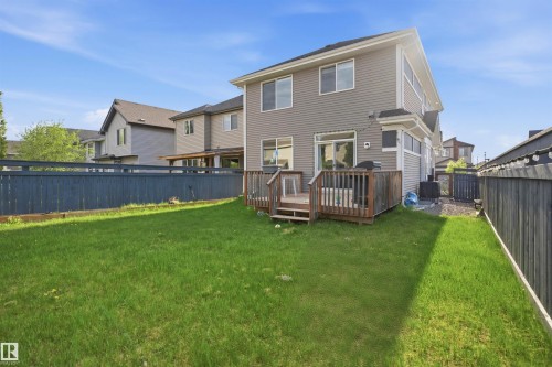 Expansive rear yard featuring a manicured lawn and a multi-level wood deck - 1234 Daniels Crescent, Edmonton, AB - Outdoor