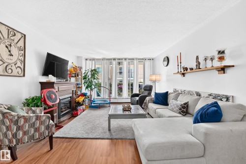Living area featuring wood-finish Laminate flooring - #407 9835 113 St Nw, Edmonton, AB 