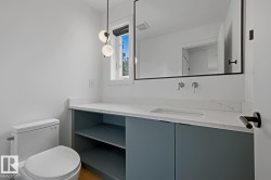 Contemporary bathroom featuring a floating vanity with integrated sink, quartz countertop, and sleek wall-mounted faucets - 