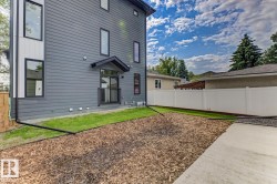 Modern exterior featuring dark gray siding and black-framed windows - 