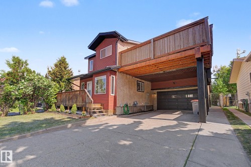 Multi-level residence featuring a red siding exterior and a concrete driveway - 60 Mcnabb Crescent, Stony Plain, AB - Outdoor