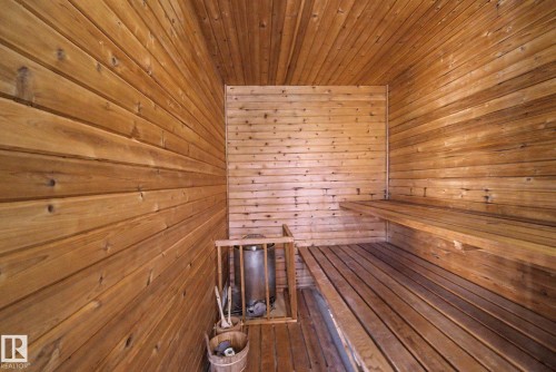 Wood-paneled sauna featuring a multi-tiered bench, slatted wood flooring, and a built-in heater - 60 Mcnabb Crescent, Stony Plain, AB - Indoor Photo Showing Other Room
