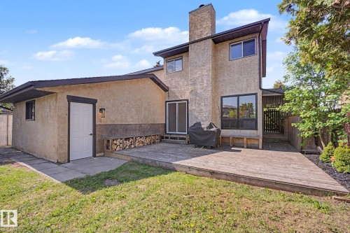 Rear exterior featuring a spacious wooden deck and adjacent patio - 60 Mcnabb Crescent, Stony Plain, AB - Outdoor With Deck Patio Veranda With Exterior