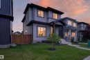 Contemporary gray siding exterior with dark trim accents, featuring a covered front entry - 548 Kleins Crescent, Leduc, AB 