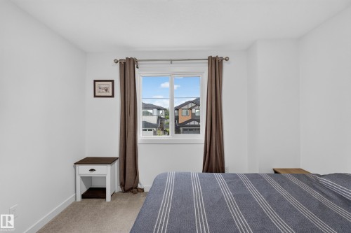 White-painted interior room featuring a double-paned window with brown drapery - 548 Kleins Crescent, Leduc, AB 
