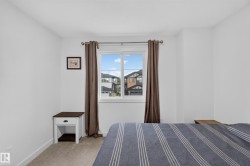 White-painted interior room featuring a double-paned window with brown drapery - 