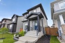 Modern two-story home featuring light gray horizontal siding and dark trim accents - 548 Kleins Crescent, Leduc, AB 