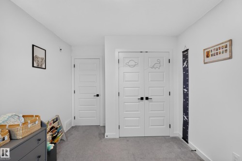 Bright interior room featuring light grey carpet flooring and white walls - 548 Kleins Crescent, Leduc, AB 