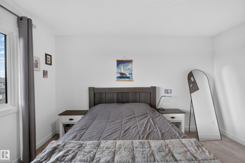 Bedroom with light gray carpet flooring and white baseboards - 548 Kleins Crescent, Leduc, AB 