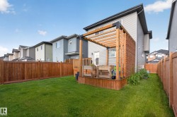 Expansive green lawn with a privacy fence - 