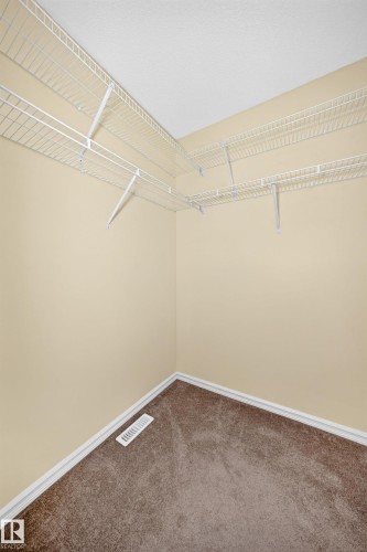 Room featuring wall-to-wall carpeting, light-toned wall paint, and white baseboards - 211 59 Street, Edmonton, AB 