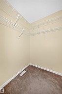 Room featuring wall-to-wall carpeting, light-toned wall paint, and white baseboards - 