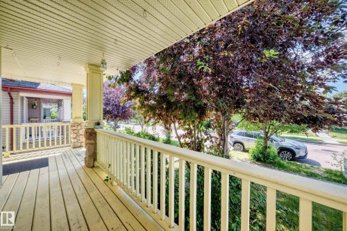 Expansive covered front porch with wood-finish flooring - 211 59 Street, Edmonton, AB 
