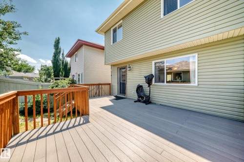 Expansive composite deck featuring a wooden railing system and stairs - 211 59 Street, Edmonton, AB 