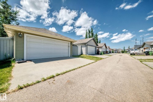 Detached garage with horizontal siding and a dual garage door - 211 59 Street, Edmonton, AB 
