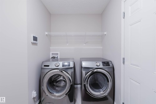 Dedicated laundry area with neutral wall tones - 16627 18 Avenue, Edmonton, AB 