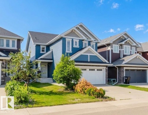 Contemporary two-story residence featuring blue siding and white trim accents - 16627 18 Avenue, Edmonton, AB 