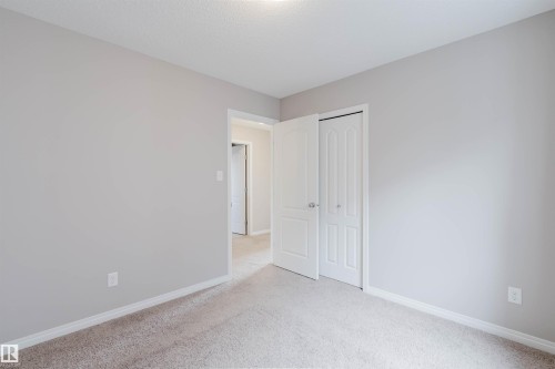 Neutral tone walls with white trim and carpeting - 16627 18 Avenue, Edmonton, AB 