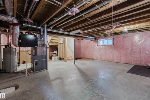 Unfinished basement featuring exposed wood joists, concrete flooring, and insulated walls - 16627 18 Avenue, Edmonton, AB 