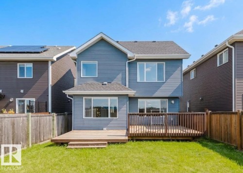 Two-story residence featuring blue horizontal siding and a gabled roofline - 16627 18 Avenue, Edmonton, AB 