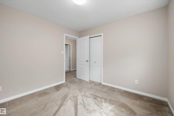 Carpeted room with neutral wall tones and white baseboards - 