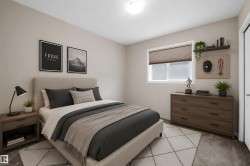Bedroom featuring a neutral color palette, a single window with blinds, a built-in floating shelf, and carpet flooring - 