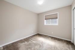 Neutral-toned walls and plush carpet flooring define this room - 