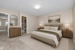 Carpeted bedroom featuring a built-in closet with shelving, a recessed ceiling light fixture, and an open doorway to another interior space - 