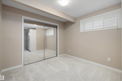 Mirrored sliding closet doors and neutral carpeting complement the beige wall tones - 
