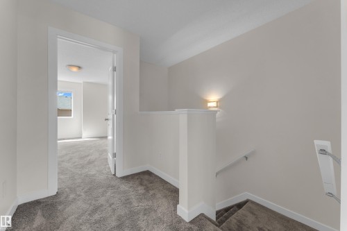 Carpeted hallway with painted walls and white baseboards - 64 14208 36 Street, Edmonton, AB 