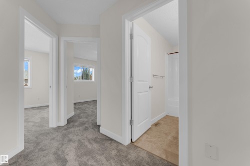 Hallway with gray carpet flooring and white trim - 64 14208 36 Street, Edmonton, AB 