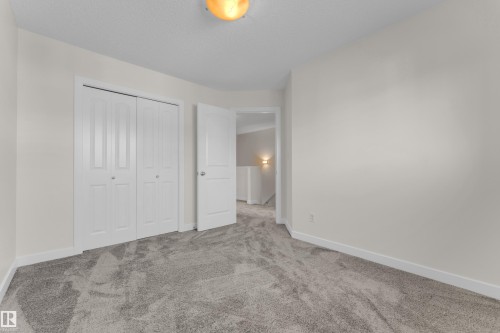 Neutral painted walls and grey carpet flooring - 64 14208 36 Street, Edmonton, AB 