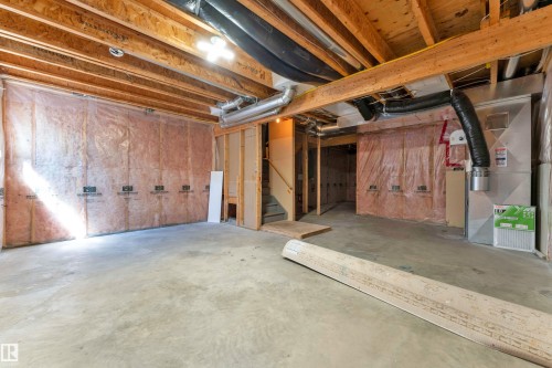 Unfinished basement area featuring exposed wooden joists and concrete flooring - 64 14208 36 Street, Edmonton, AB 